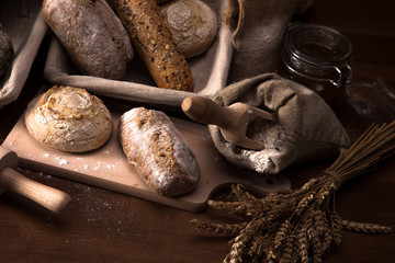 Fresh bread and wheat on the wooden table