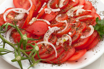 slices of tomatoes with the onion and herbs