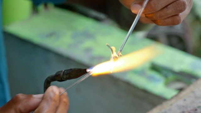 Craftsman hands working to create glassware