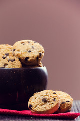 Chocolate cookies in a bowl, on a wooden table.