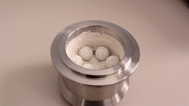 A stone miller with white stones