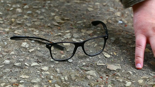 Man looking for fallen eyeglasses