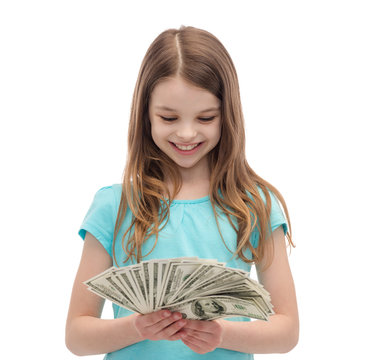 smiling little girl looking at dollar cash money