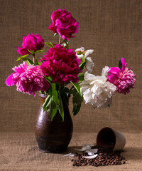 Still life with peonies and cup of coffee beans