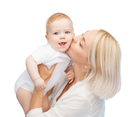 happy mother kissing smiling baby