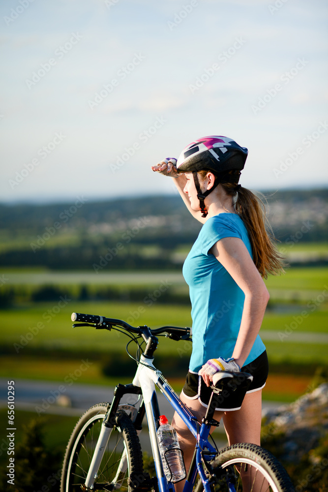 Canvas Prints healthy cheerful young woman riding mountain bike countryside