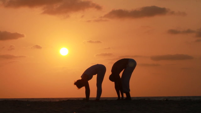 Silhouette of a beautiful Yoga couple