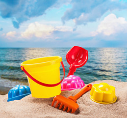 colorful toys for childrens sandboxes against the sea
