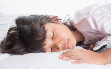 Obraz na płótnie Canvas Young Asian Malay girl sleeping peacefully on her bed