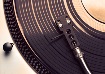 Top view of old fashioned turntable playing a track