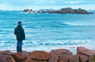 Boy and Tregastel coast view (Brittany, France)