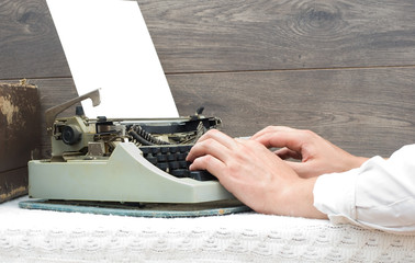 Hands typing on a typewriter