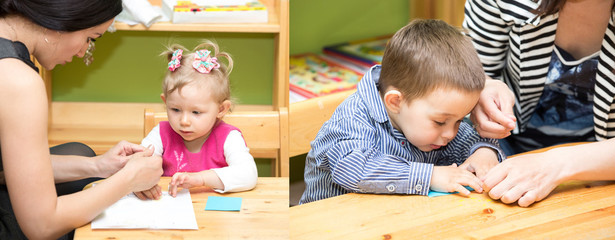 Two little kids drawing with colorful pencils in preschool