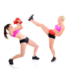 sport training of two boxing young woman, studio over white