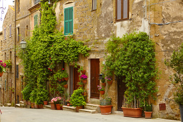 Fototapeta na wymiar Vintage street decorated with flowers, Tuscany, Italy