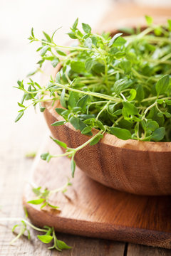 fresh thyme herb in wooden bowl