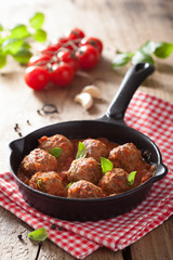 meatballs with tomato sauce in black pan