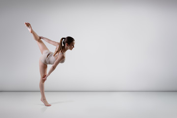 young beautiful dancer teen girl dancing and jumping, studio ser