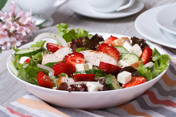 Salad with chicken, strawberries and vegetables close up