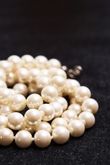 White pearls on black background.