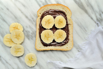 Bread with chocolate cream and slices of banana
