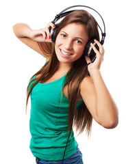 Naklejka premium young woman listening to music with headphones isolated on white
