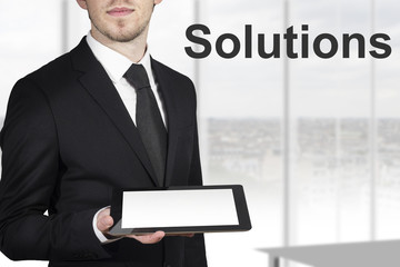 businessman in black suit holding tablet pc solutions