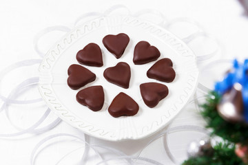 Christmas chocolate cookies on white plate.