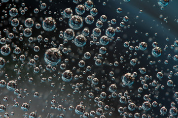 Air bubbles in a liquid. Abstract dark background. Macro