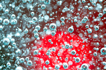 Air bubbles in a liquid. Abstract red background. Macro