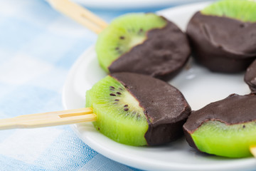 Kiwi with chocolate on a stick