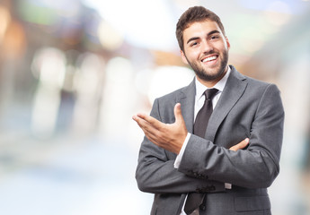 handsome young successful man doing a welcome gesture