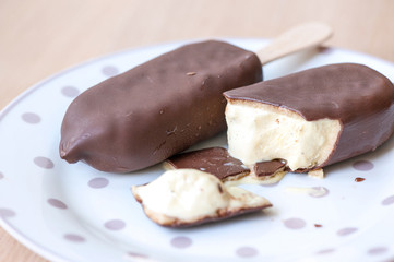 Bitten piece of eskimo ice-cream. Indoors closeup.