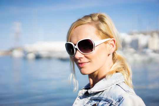 Beautiful natural young blond woman in sunglasses