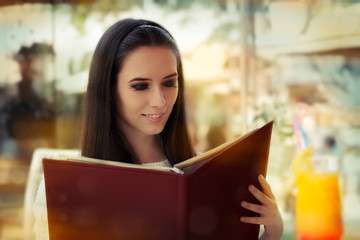 Young Woman Choosing from a Restaurant Menu