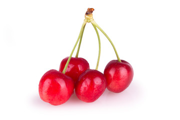 four ripe red cherries