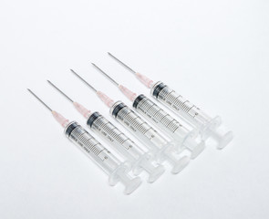 Close-up of medical syringe in row
