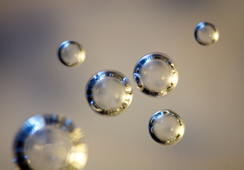 Air silvery bubbles in water, extreme closeup.