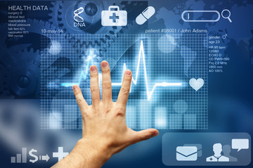 hand touching screen with medical data