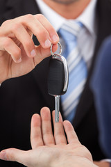 Agent Giving Car Key To Man