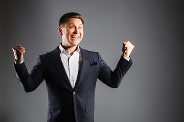 young happy man with hands lifted upwards