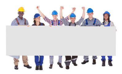 Multiethnic Manual Workers Holding Blank Banner