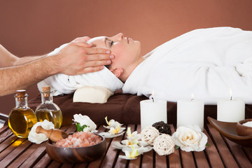 Obraz na płótnie Canvas Relaxed Woman Receiving Head Massage At Spa