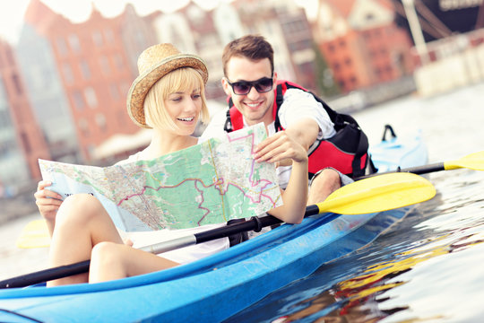 Young couple with a map in a canoe