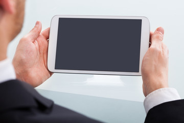 Businessman Holding Digital Tablet In Office