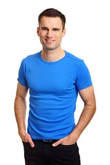 Fototapeta premium Handsome man in blue shirt with hands at pockets
