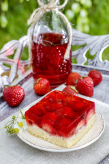 Strawberry cake on wooden tray in the garden