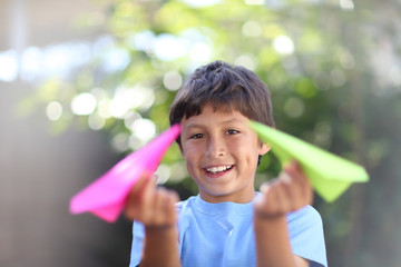 Boy playing with paper plane