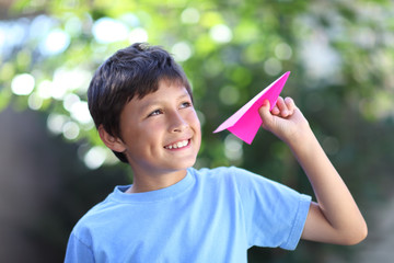 Boy playing with paper plane