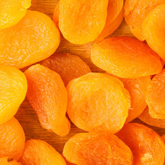 Heap of dried apricots close-up food background